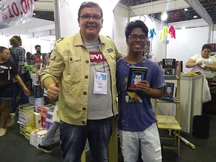 J. Angelini com leitor em feira do livro